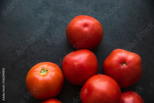 red tomatoes on a dark kitchen counter