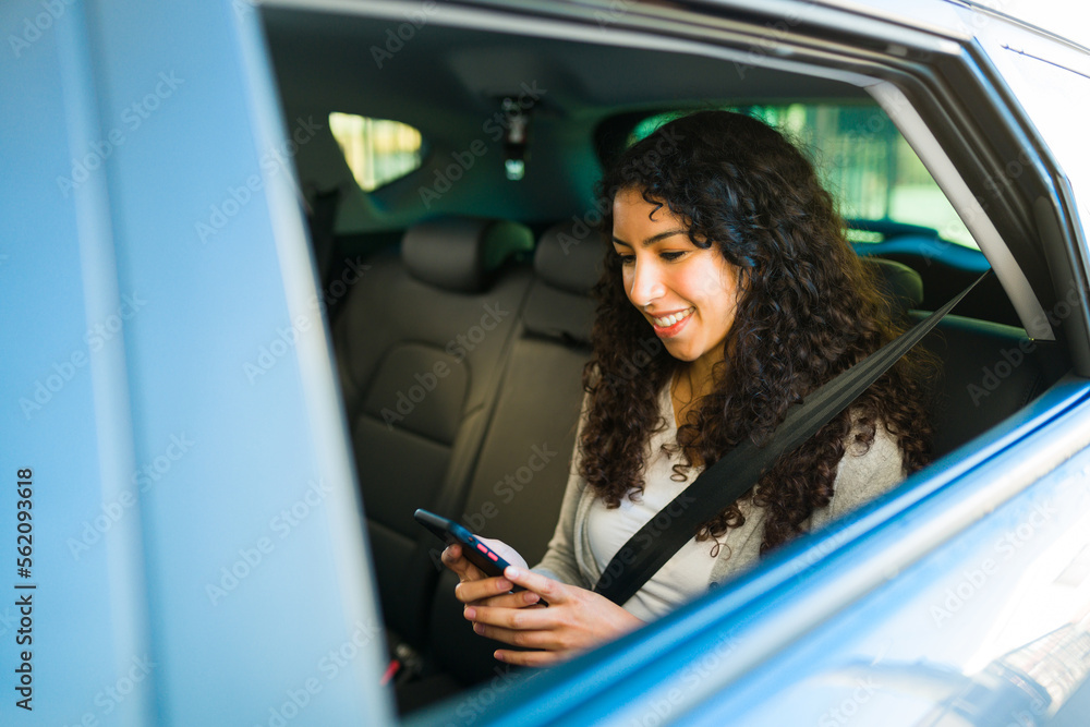 Smiling woman passenger using the rideshare app