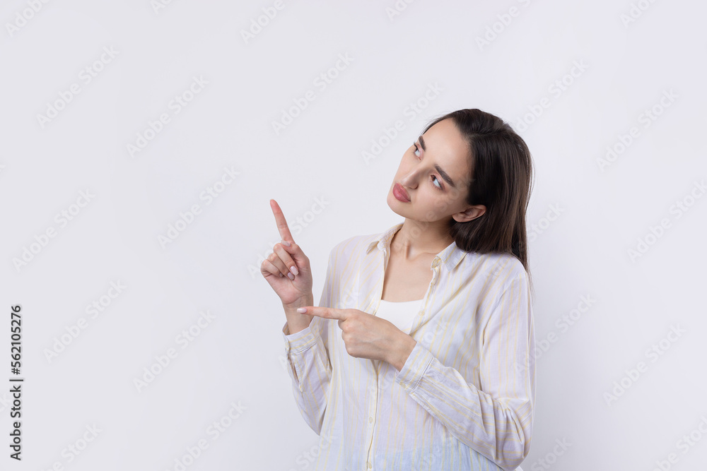 Happy young caucasian female in a shirt pointing fingers away Happy young caucasian female in a shirt pointing fingers away