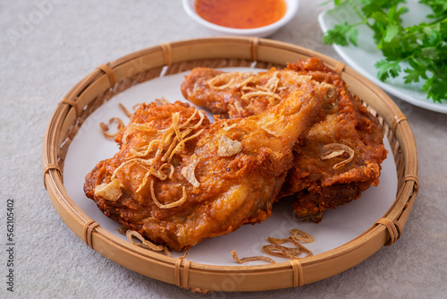 Fényképezés Crispy fried chicken with deep fried shallot in wicker basket (Hat Yai fried chicken), Thai food style