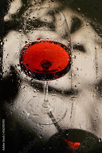 Glass Of Dry Red Wine Through Rainy Window