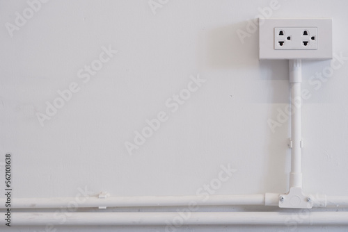 Wallpaper Mural White power outlet with the wire on the white tube on the white wall background with copy space Torontodigital.ca