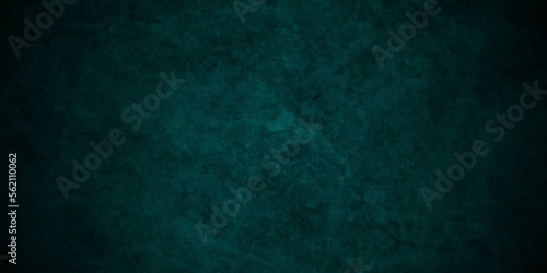 Dark green background with grunge backdrop texture, watercolor painted mottled green background, colorful bright ink and watercolor textures on black paper background.
