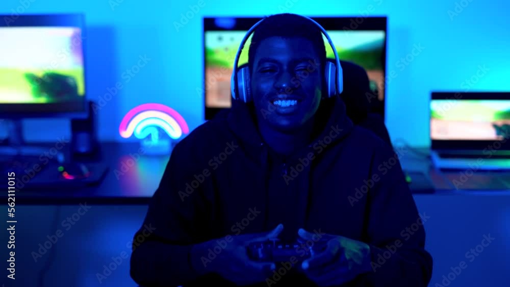 Young african boy smiling on camera with computer in background - Gaming concept
Young african boy smiling on camera with computer in background - Gaming concept