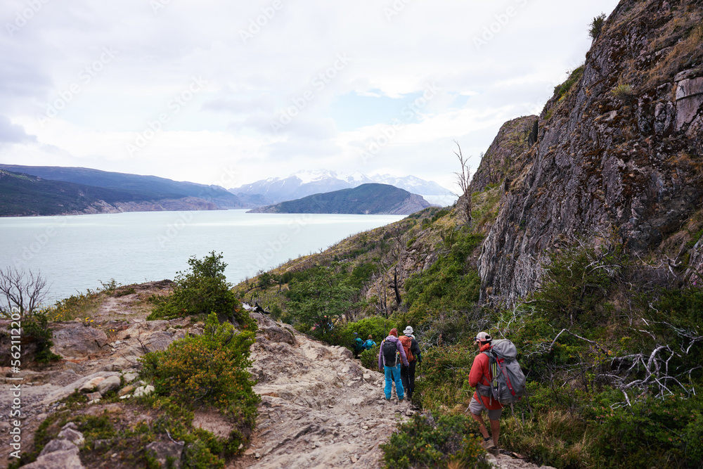 group of hikers walking the trail on the way to glacier Grey in Torres del Paine National Park