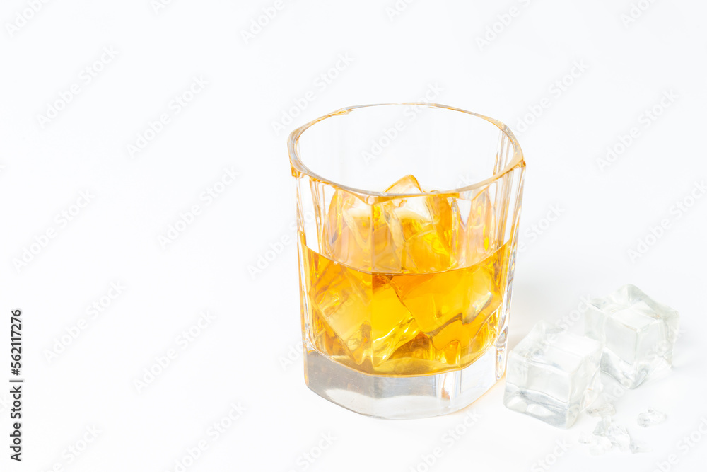 Glass of whiskey or brandy with ice. Strong alcohol background Glass of whiskey or brandy with ice. Strong alcohol background