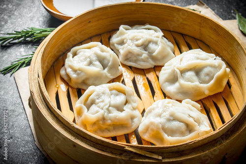 Fresh dumplings of manta with meat in a bamboo steamer.