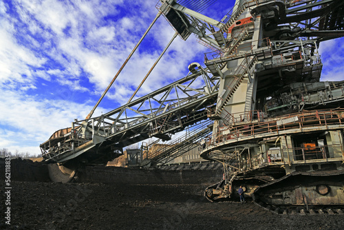 Bucket-wheel excavator during excavation at the surface mine. Huge excavator on open pit mine.