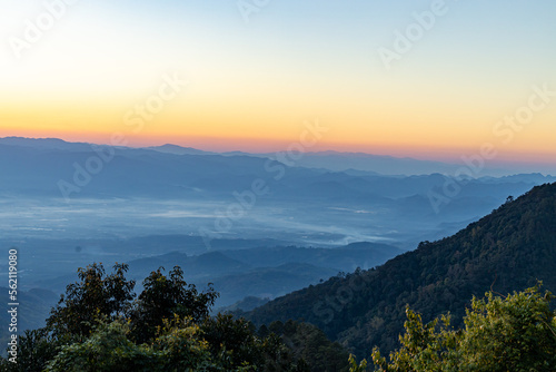 View of Beautiful landscape in the mountains at sunrise in the morning. Beautiful sky background and the foggy hills covered. Nature tourism, healthy lifestyle concept and beautiful nature.