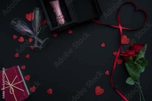 Beautiful valentines day background with red hearts, roses, gift box and champagne on black banner background. Wedding, birthday, Valentine's Day. 14 February. 