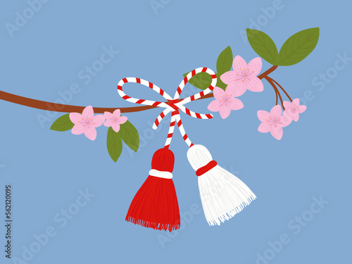 Martisor talisman on a branch. Traditional accessory for holiday of early spring in Romania and Moldova. Red and White spring symbol. photo