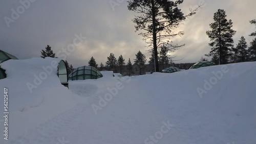 Glass igloo covered with snow, Kakslauttanen, Finland photo