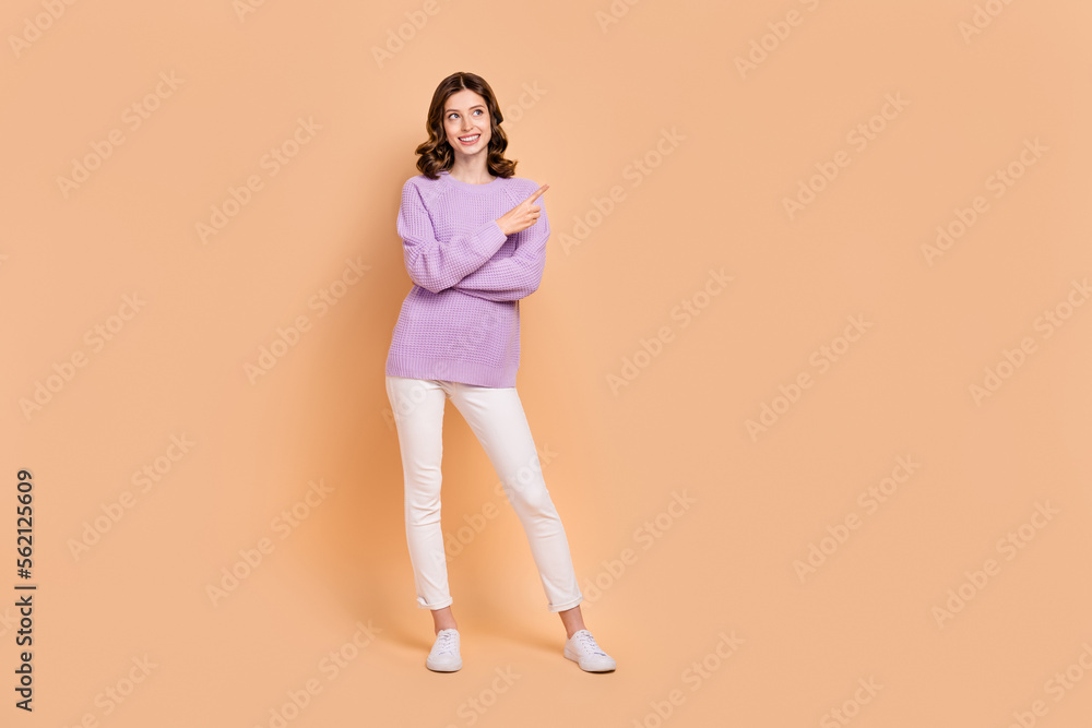 Full length photo of gorgeous lovely lady wear trendy clothes presenting empty space black friday sale isolated on beige color background Full length photo of gorgeous lovely lady wear trendy clothes presenting empty space black friday sale isolated on beige color background