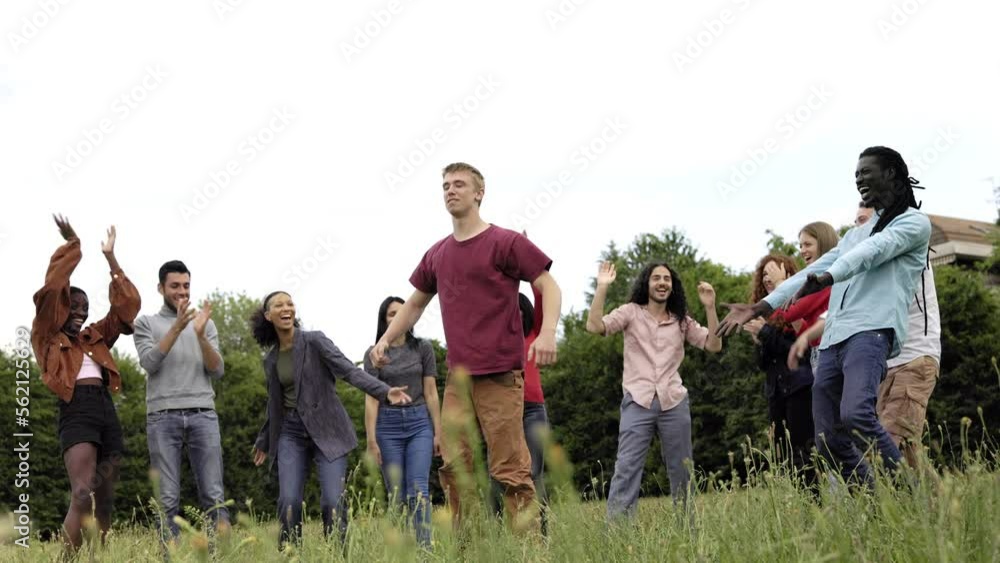 Happy multiracial group of friends having fun doing backflip parkour jump back outdoor Happy multiracial group of friends having fun doing backflip parkour jump back outdoor