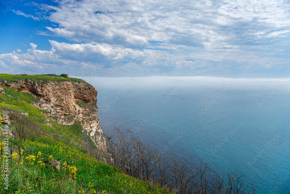 Rocky seashore and fog over the water. Cape Kaliakra, Bulgaria. Rocky coast of Cape with sea views.