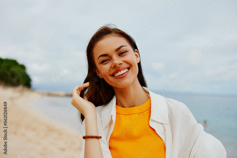 Portrait of a happy woman smile with teeth with long hair brunette summer travel and feeling of freedom, balance Portrait of a happy woman smile with teeth with long hair brunette summer travel and feeling of freedom, balance