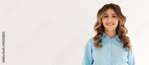 Pretty smiling joyfully female with dark hair, dressed casually, looking with satisfaction at camera, being happy. Studio shot of good-looking beautiful woman isolated against blank studio wall.