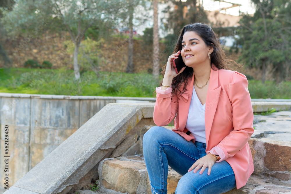 Girl talking on the phone sitting on a staircase Girl talking on the phone sitting on a staircase