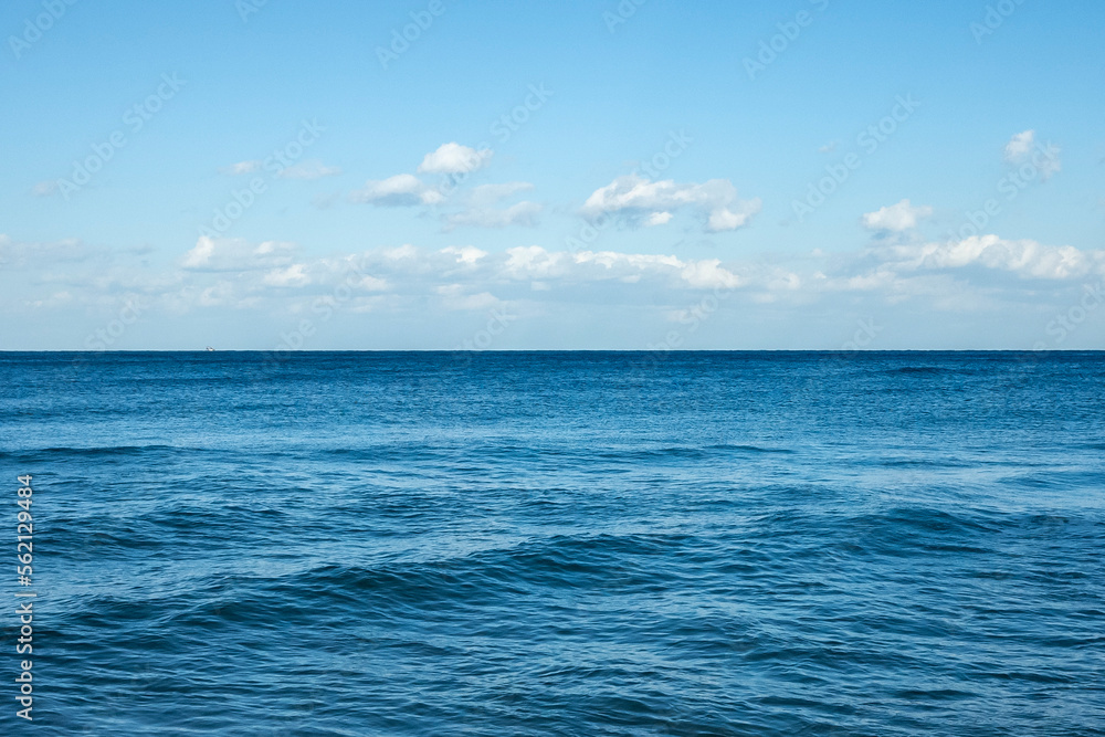 The water ripples in the sea against the backdrop of a cloudy blue sky. The color of the blue sky is heartbreaking. Emotionally disturbing colors High resolution photo editing source images