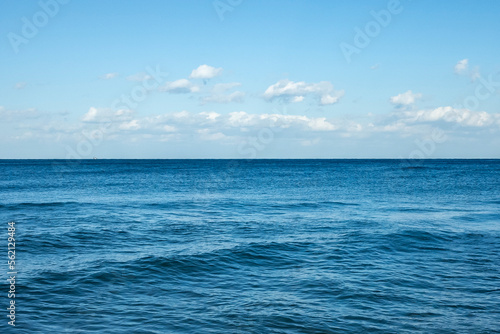 The water ripples in the sea against the backdrop of a cloudy blue sky. The color of the blue sky is heartbreaking. Emotionally disturbing colors High resolution photo editing source images
