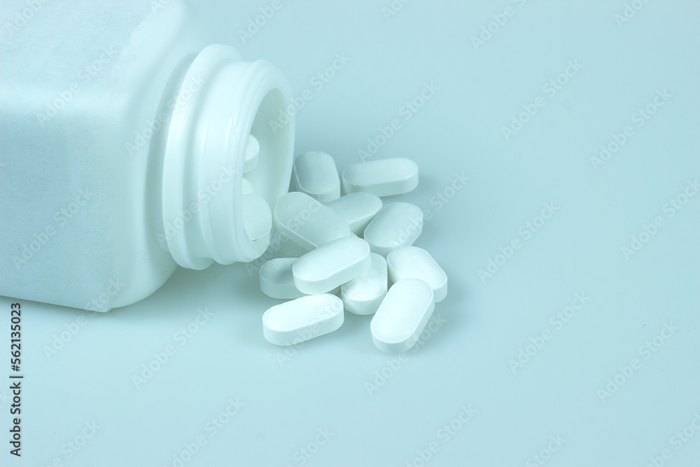pills and bottle on white background pills and bottle on white background
