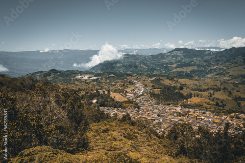 Wide panorama of the colonial village (pueblo) of Jerico (Jericó), Antioquia, Colombia, with a blue sky and the Andes Mountains in the background. From the Cerro las Nubes (Mount of the Clouds).