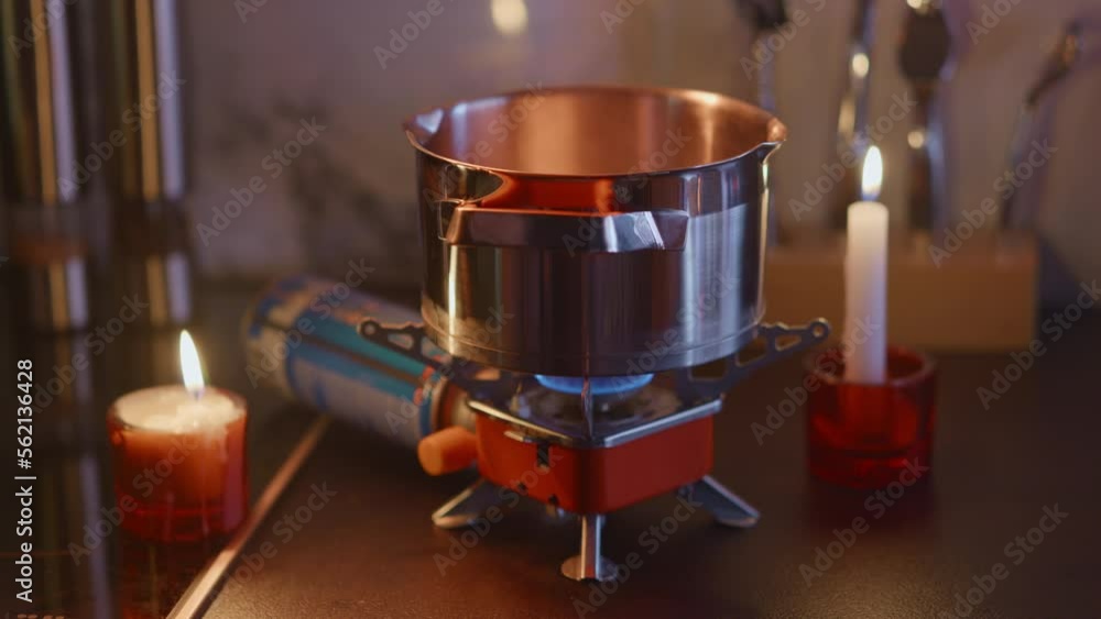 Cooking diner on a portable stove during blackout, tourist gas burner