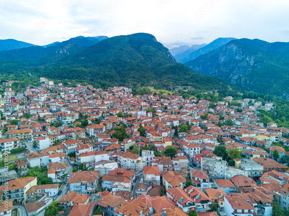 Greek town of Litochoro with small houses against the backdrop of the Mount Olympus and a cloudy sky