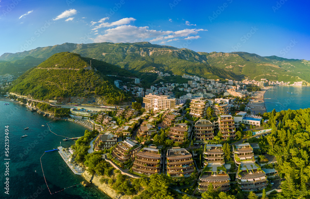 Panorama of hotel Dukley with chic apartments, gardens and sandy beaches near the Adriatic Sea against the backdrop of the coastal Montenegrin cities