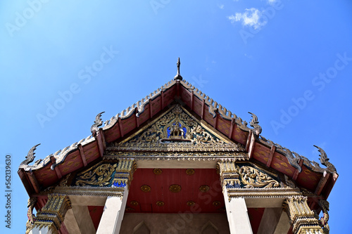 BANGKOK, THAILAND - January 16, 2023 : Part of the Roof of a temple in Thailand. Traditional Thai style pattern on the roof of a temple with Blue Sky Background. photo