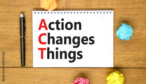 ACT action changes things symbol. Concept words ACT action changes things on white note on a beautiful wooden background. Business and ACT action changes things concept. Copy space.