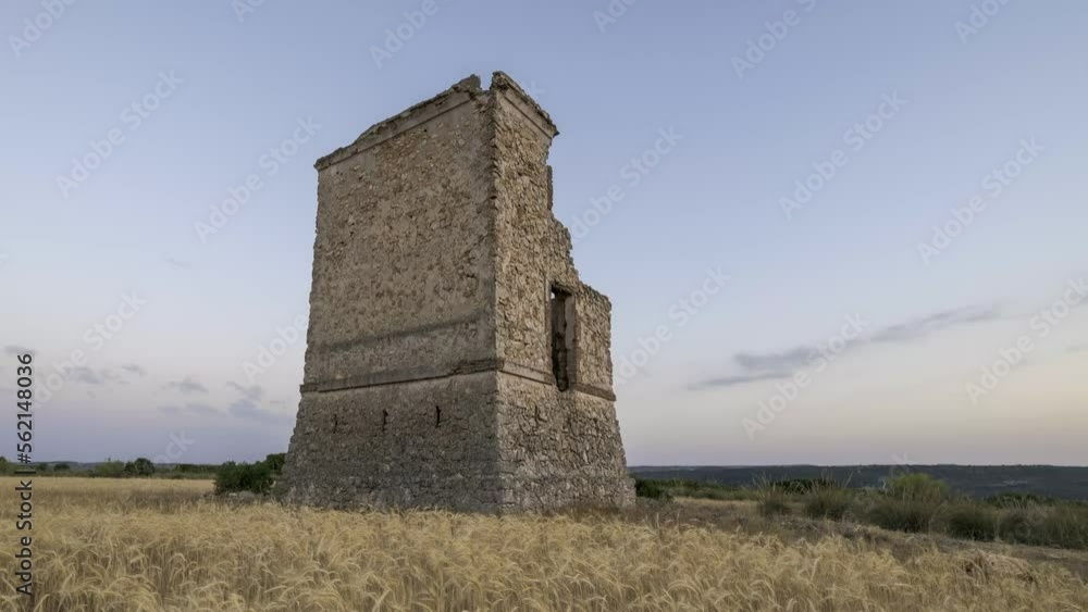Aged tower in field in evening Aged tower in field in evening
