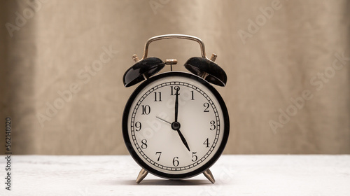 Classic black clock old vintage alarm, Retro alarm clock on table , background with copy space, Retro alarm morning