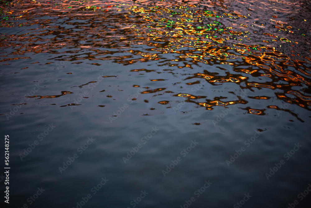 An abstract image of water with a reflection of evening electric illumination. An abstract image of water with a reflection of evening electric illumination.