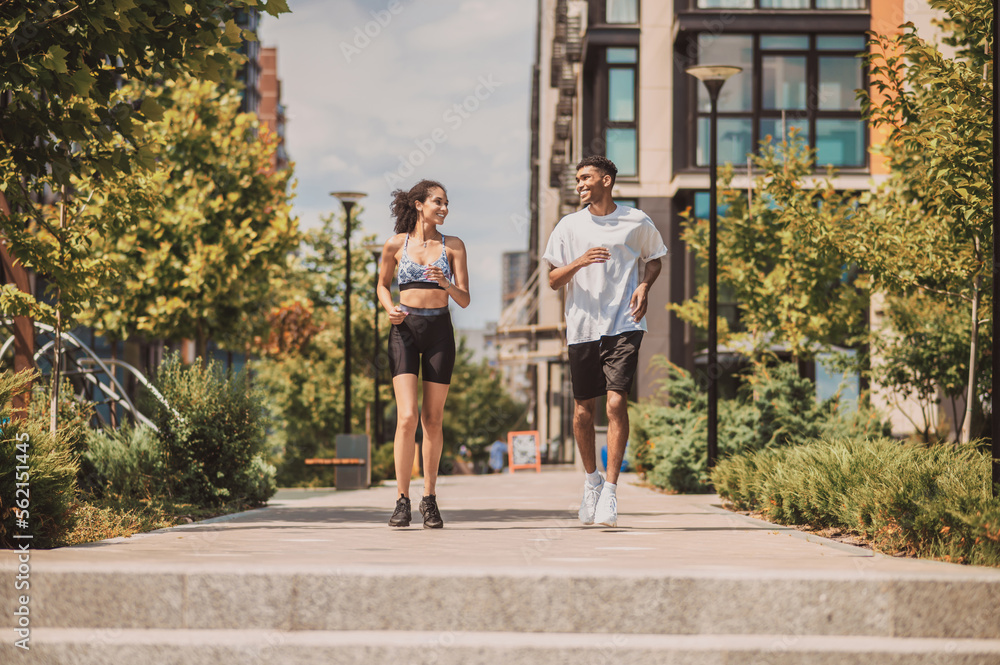 Fototapeta premium Cheerful couple enjoying their morning jog outdoors