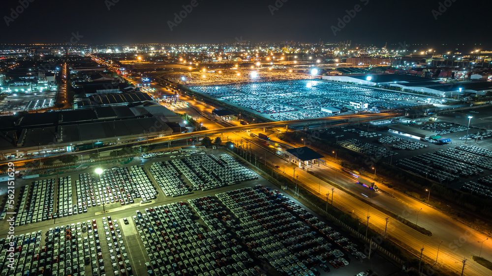 night scene shot over lighting new cars lined up at Industrial factory and commercial port