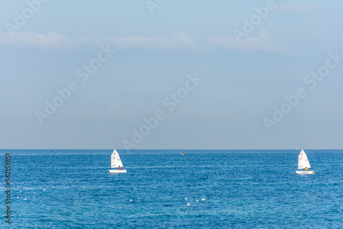 Two sailing boats on the blue Mediterranean in Algiers city. Water sports.