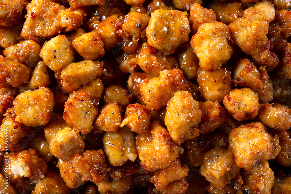 A top down view of a catering tray of orange chicken. A top down view of a catering tray of orange chicken.