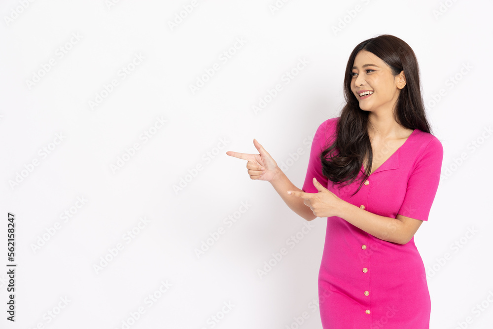 Young elegant beautiful Asian woman smiling and pointing to empty copy space isolated on white background Young elegant beautiful Asian woman smiling and pointing to empty copy space isolated on white background