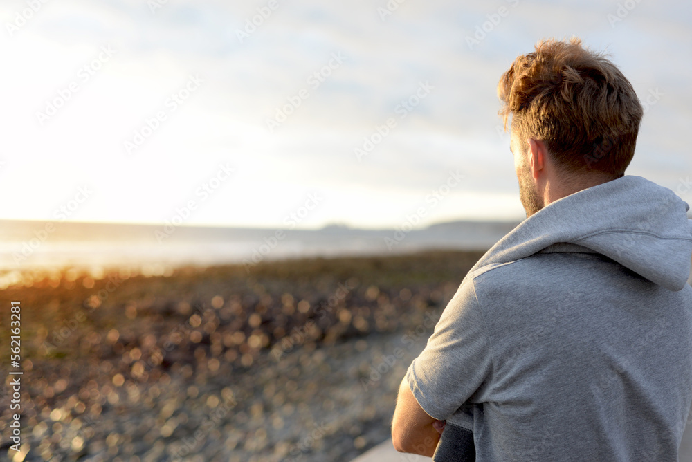 Young hipster adult enjoys holidays walking by the sunset light.