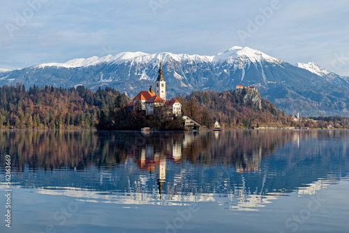 Sunrise winter scenery of magical Lake Bled in Slovenia. A winter tale for romantic experiences. Mountains with snow in the background. Church of the Mother of God on a little Island in the lake. © stu.dio