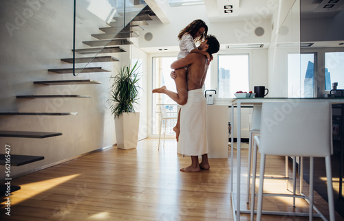 Young couple lifestyle moments at home. Playful young woman and man having fun in a beautiful luxury penthouse loft apartment