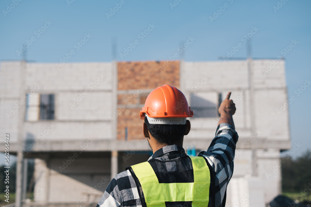 Asian male engineer inspecting a building structure. Asian male engineer inspecting a building structure.