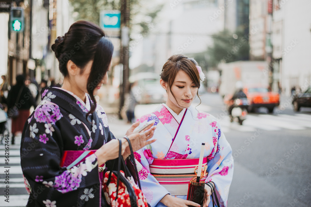 Two japanese girls wearing kimonos traditional clothes, lifestyle moments Two japanese girls wearing kimonos traditional clothes, lifestyle moments