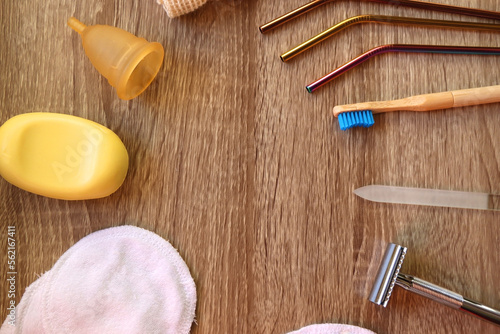Various zero waste beauty products and kitchen utensils on wooden background. Top view.