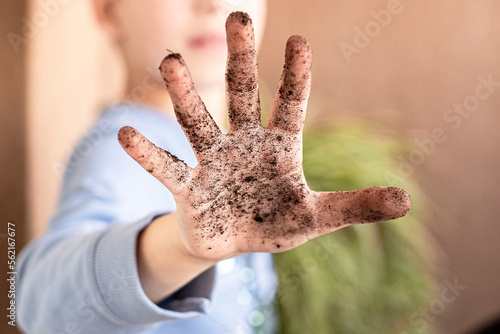 Close up child hand is dirty in the soil
