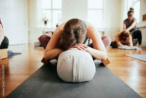 Woman practicing the supported butterfly pose photo