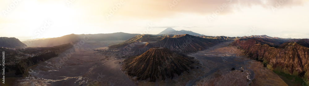 View from above, stunning panoramic view of the Mount Batok, Mount Bromo and the Mount Semeru in the distance illuminated at sunrise. Mount Bromo is an active volcano in East Java, Indonesia.