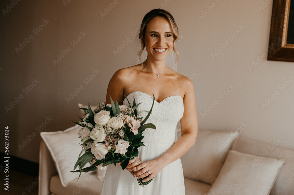 woman in wedding dress holding bouquet woman in wedding dress holding bouquet