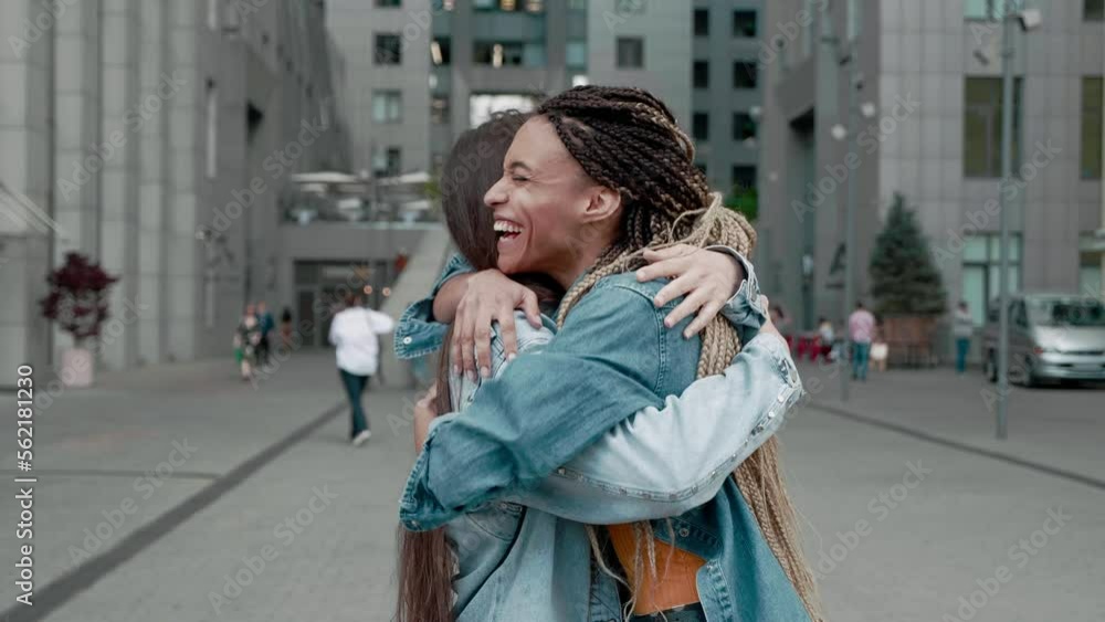 friends hugging after separation Asian and African American 2 students ...